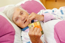 elderly person taking medicine